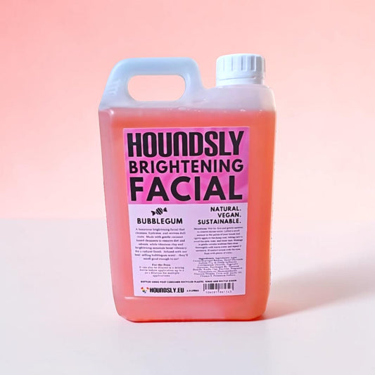 Houndsly Brightening Facial Bubblegum, a pink liquid in a jug with a bright pink label. Natural, vegan, sustainable.