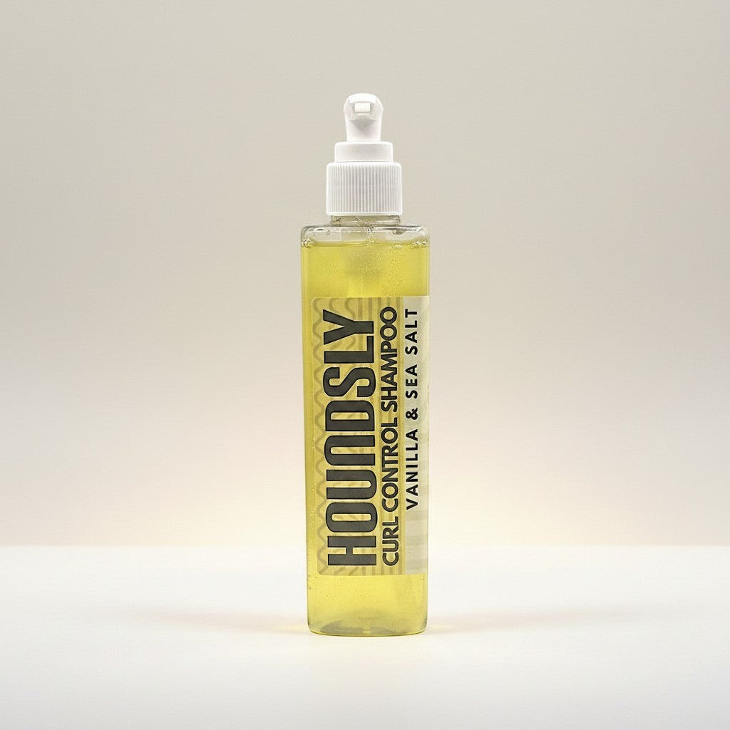 Houndsly Curl Control Dog Shampoo in Vanilla & Sea Salt scent, a clear yellow liquid in a pump bottle. For curly coats.