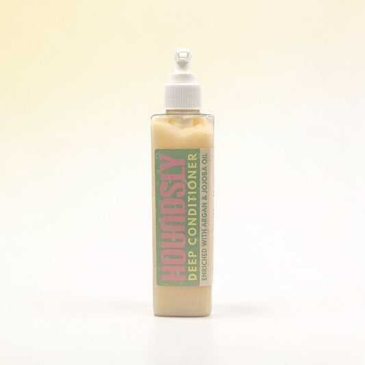 Houndsly Deep Conditioner for Dogs, enriched with Argan & Jojoba Oil, in a clear bottle with a pump dispenser.