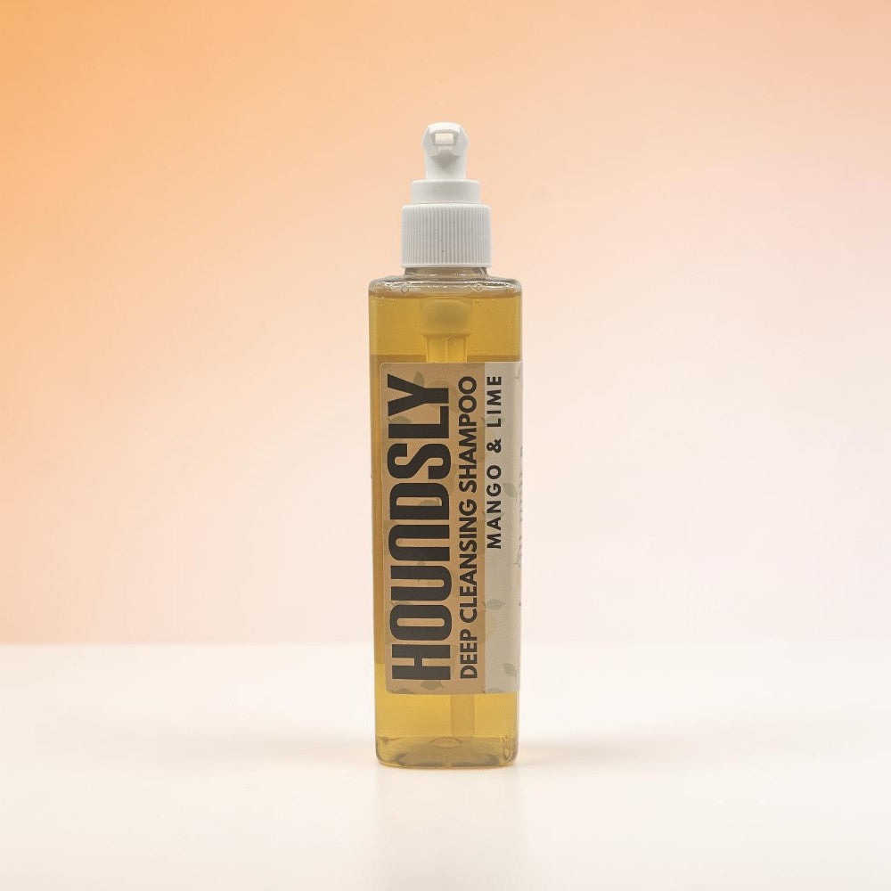 Houndsly Deep Cleansing Dog Shampoo in Mango & Lime scent, a clear yellow liquid in a pump bottle.