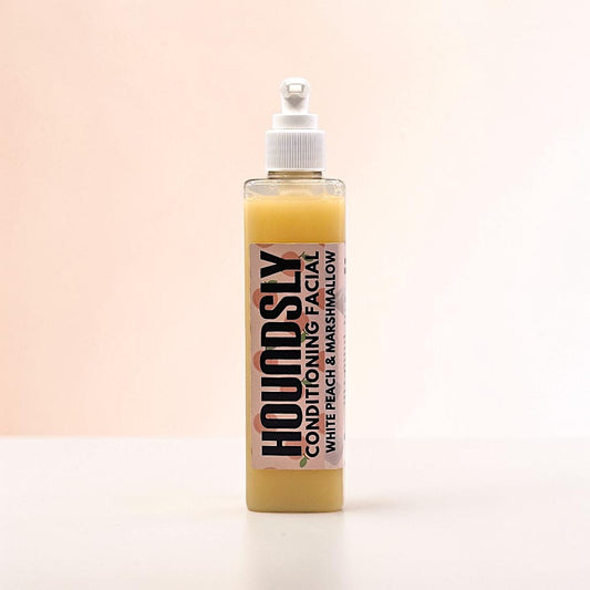 Houndsly EU Pet Products White Peach & Marshmallow Dog Facial conditioning treatment in a clear bottle with a pump dispenser.