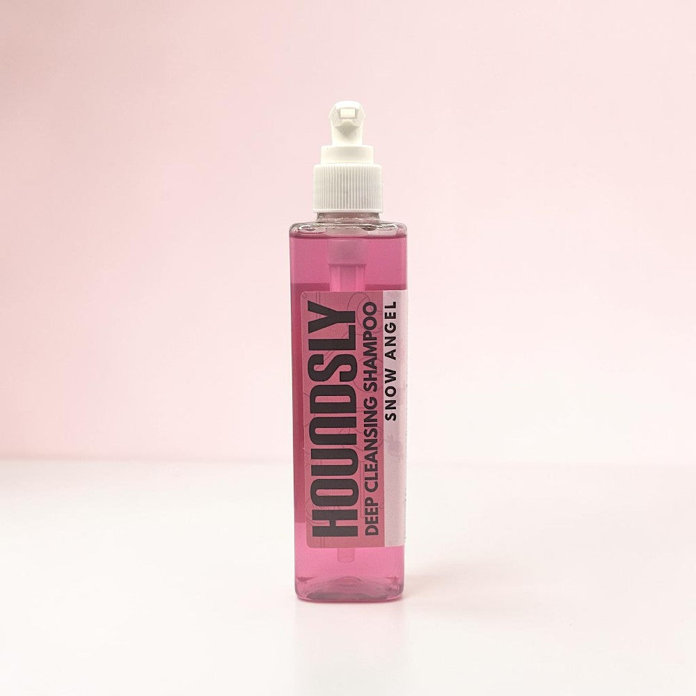 Houndsly EU Pet Products Snow Angel deep cleansing dog shampoo in a clear pump bottle with pink liquid.